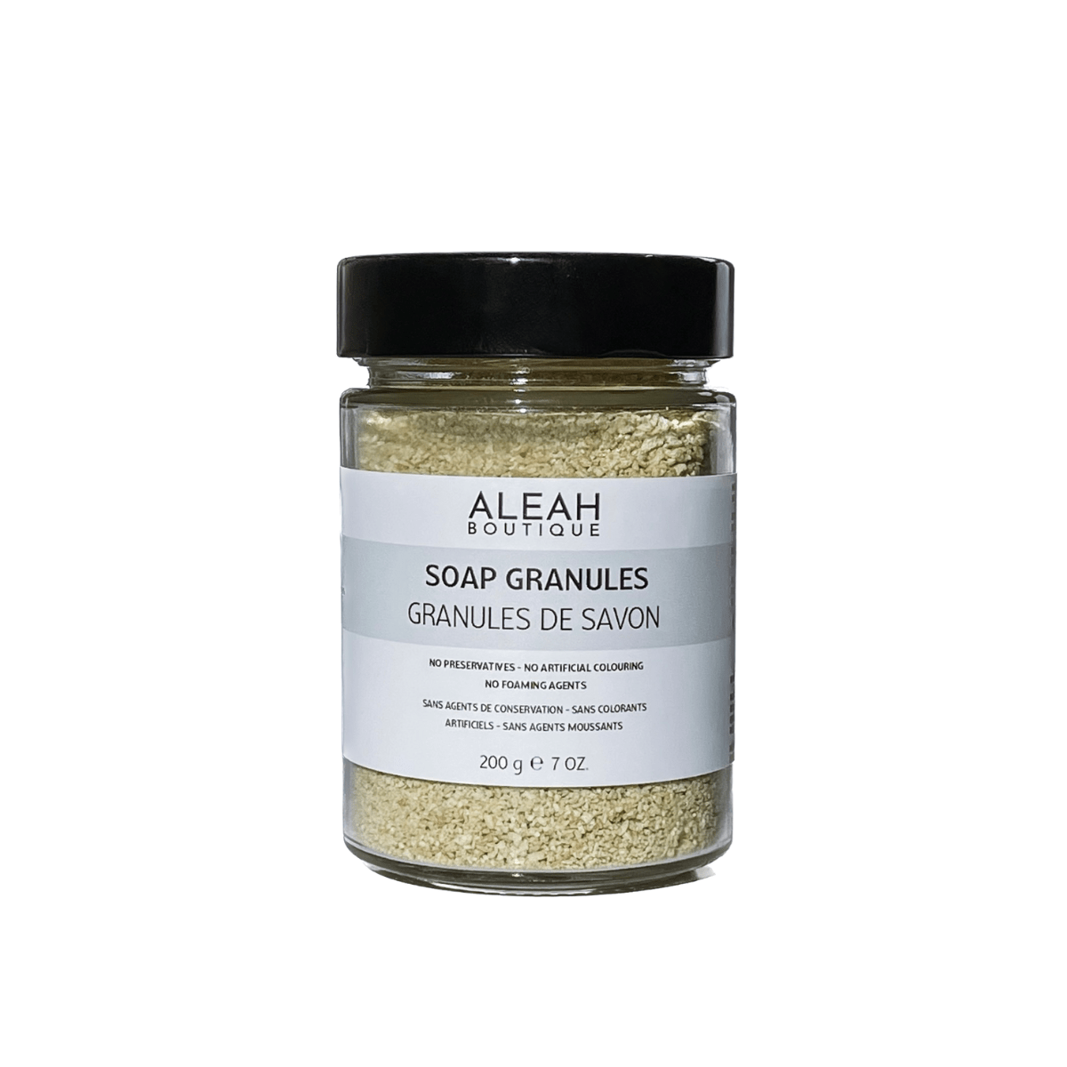 Olive oil soap granules in glass jar with black cap